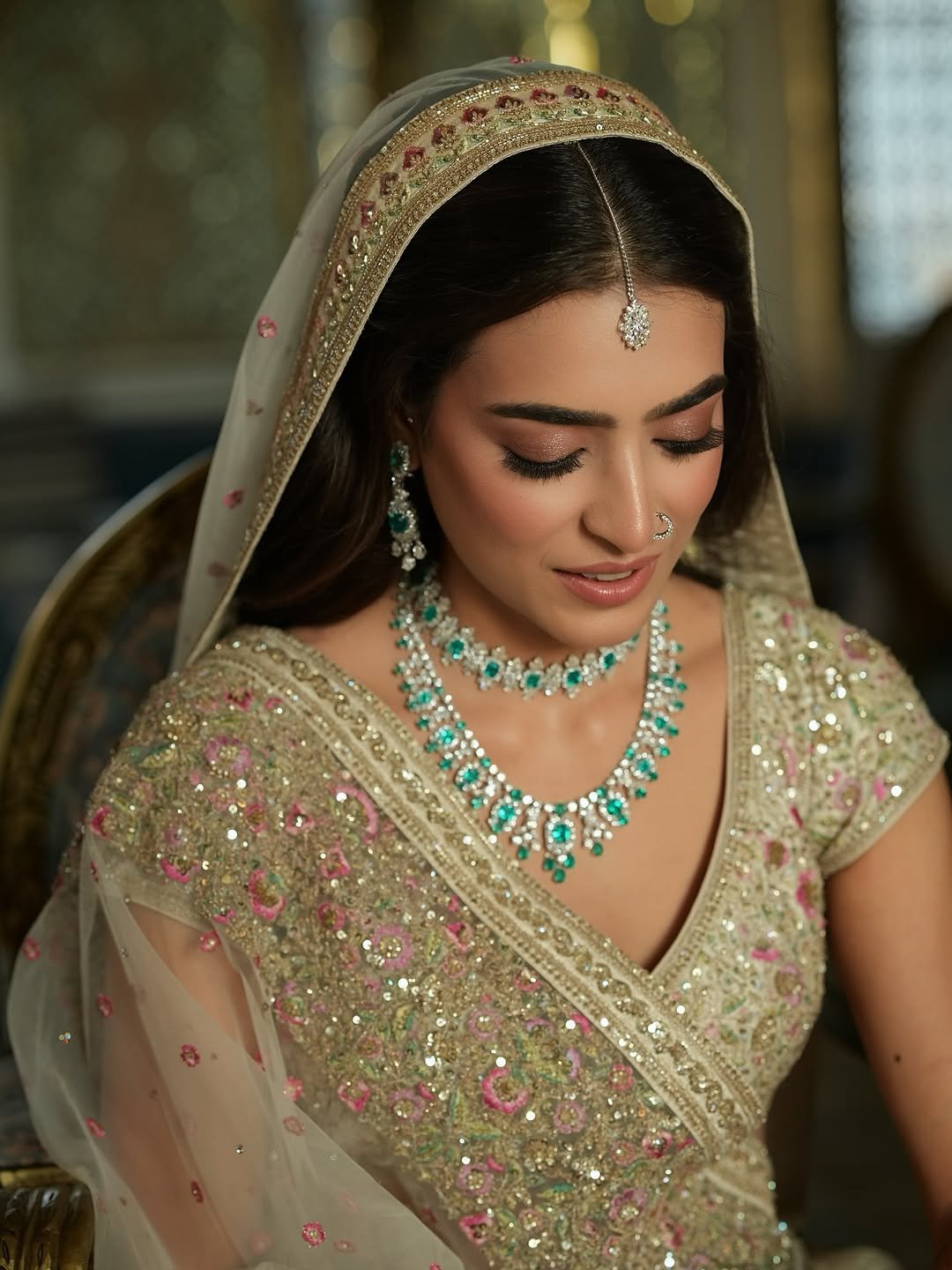 Soft bridal look with rose-toned eyes, nude lips, dupatta and emerald bridal jewellery