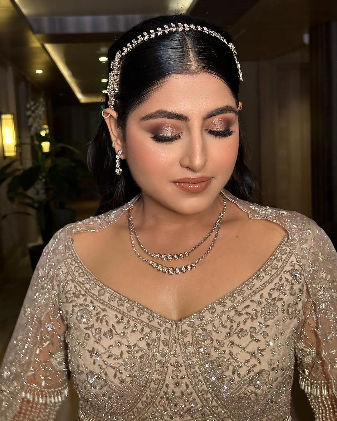 Reception bridal glam with luminous skin, shimmer eyes and a polished evening finish