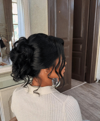At home hair stylist creating an elegant updo during hair styling services at home